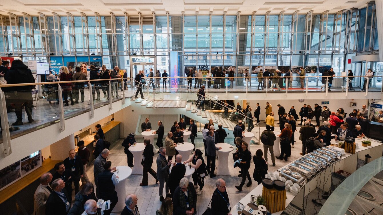 Vogelperspektive auf die Lobby des Ludwig Erhard Hauses der IHK Berlin. Es herrscht reges Treiben und viele Menschen sind im Haus. Sie befinden sich auf dem IHK Kongress 2026 im Ludwig Erhardt Haus der IHK Berlin.