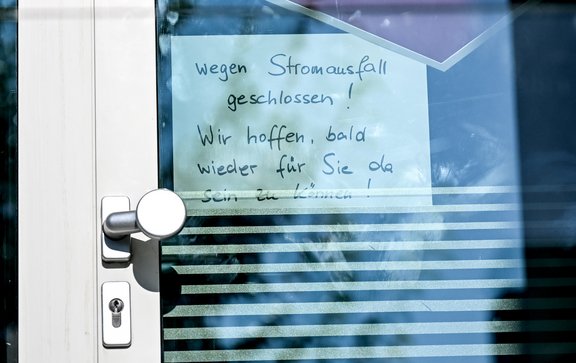 Blick auf beleuchtete Bürogebäude bei Abenddämmerung unter bewölktem Himmel