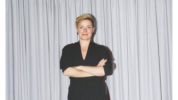 Eine weiße, blonde Frau im schwarzen Kleid